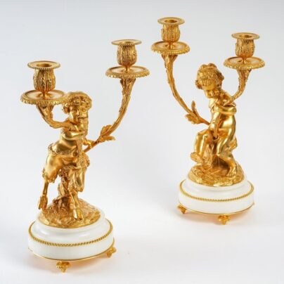 Paire de candélabres style Louis XVI en bronze doré Un Amour et Un Faune d'après Clodion et Delarue