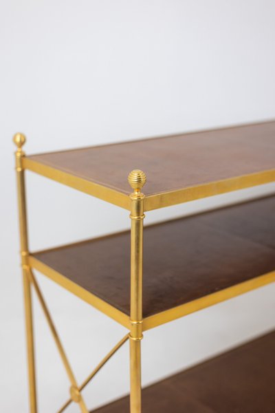 Casa Jansen. Console in ottone dorato e pelle fulva. Circa 1970.  LS64292509I