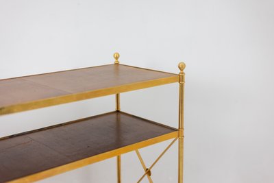 Casa Jansen. Console in ottone dorato e pelle fulva. Circa 1970.  LS64292509I