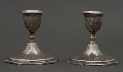 Pair of 19th century Persian silver candlesticks, engraved with bird design, hallmarked 84