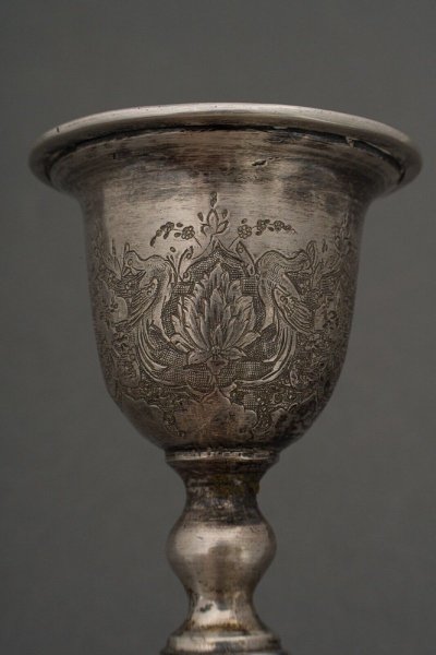 Pair of 19th century Persian silver candlesticks, engraved with bird design, hallmarked 84