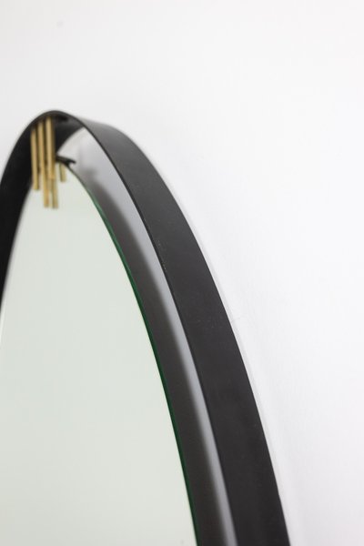 Lacquered and patinated brass mirror, ovoid shape. 1950s/60s. LS6351736M