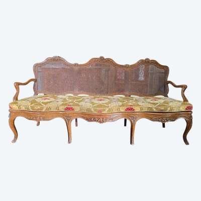 Louis XV period sofa with cane base, Lyonnais work attributed to Pierre Nogaret.