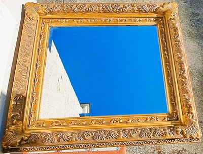 Wooden and gilded stucco bevelled mirror in the Louis XIV Regency style, early 20th century