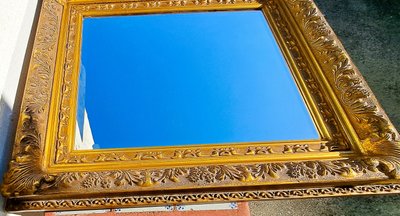 Wooden and gilded stucco bevelled mirror in the Louis XIV Regency style, early 20th century