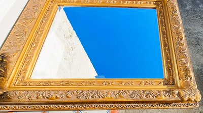 Wooden and gilded stucco bevelled mirror in the Louis XIV Regency style, early 20th century