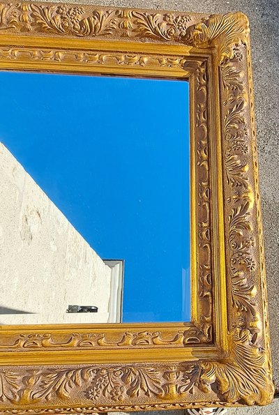 Wooden and gilded stucco bevelled mirror in the Louis XIV Regency style, early 20th century