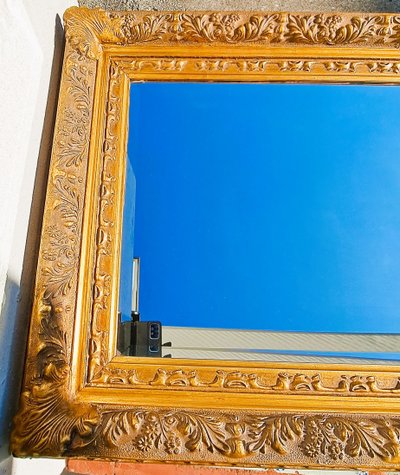 Wooden and gilded stucco bevelled mirror in the Louis XIV Regency style, early 20th century