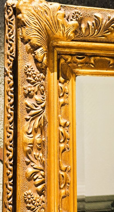 Wooden and gilded stucco bevelled mirror in the Louis XIV Regency style, early 20th century