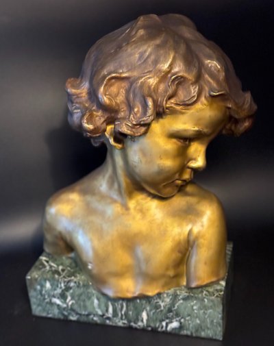 J.-M. CAMUS Large bust of a child in gilded and patinated bronze.