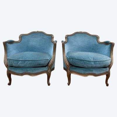 Paire de fauteuils bergères de style Louis XV en velours bleu et bois doré 