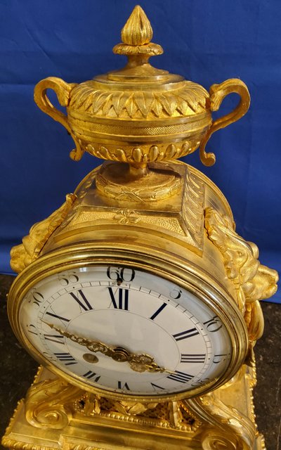 Louis XVI style clock in gilded bronzes with Lions' heads Greek decor 19th century