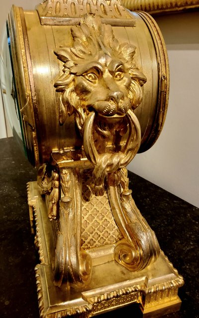 Louis XVI style clock in gilded bronzes with Lions' heads Greek decor 19th century