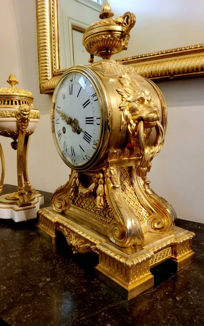 Louis XVI style clock in gilded bronzes with Lions' heads Greek decor 19th century