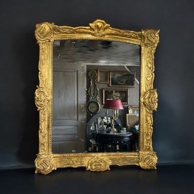 LARGE XVIIIth CENTURY MIRROR IN GOLDEN SCULPTURED AND STUQUED WOOD WITH MERCURY ICE