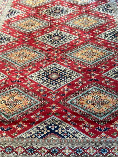 Grande tappeto pakistano firmato in lana lavorato a mano con disegno geometrico su fondo rosso