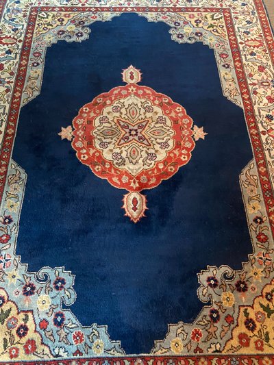 NAIN hand-knotted wool oriental rug with central medallion on midnight blue background