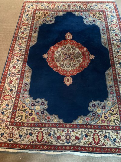 NAIN hand-knotted wool oriental rug with central medallion on midnight blue background