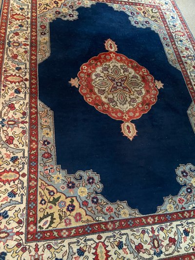 NAIN hand-knotted wool oriental rug with central medallion on midnight blue background