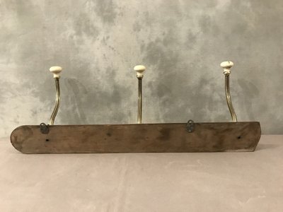 Late 19th century brass and ceramic coat rack and coat hooks on wood