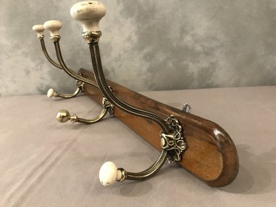 Late 19th century brass and ceramic coat rack and coat hooks on wood