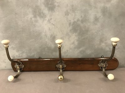 Late 19th century brass and ceramic coat rack and coat hooks on wood