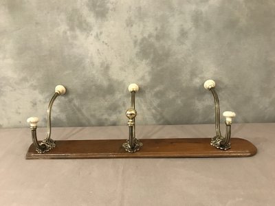 Late 19th century brass and ceramic coat rack and coat hooks on wood