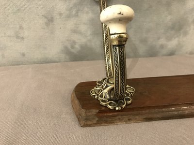 Late 19th century brass and ceramic coat rack and coat hooks on wood