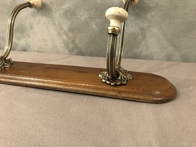 Late 19th century brass and ceramic coat rack and coat hooks on wood