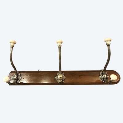 Late 19th century brass and ceramic coat rack and coat hooks on wood