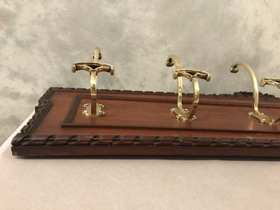 Set of 6 19th century bronze coat hooks on wood