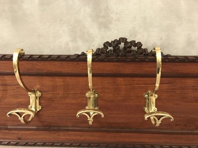 Set of 6 19th century bronze coat hooks on wood