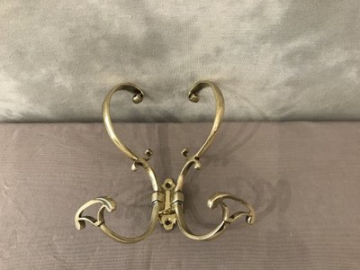 19th century double coat hook in polished and varnished brass
