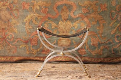 Curule stool seat in polished wrought iron with brass ornamentation, 20th century