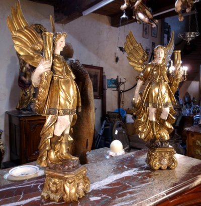 Large pair of gilded wooden torch-bearing angels, 18th century