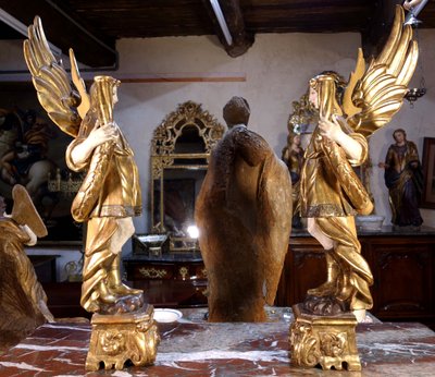Large pair of gilded wooden torch-bearing angels, 18th century