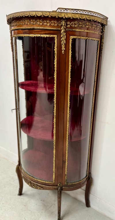 Napoleon III-style display cabinet in mahogany and veneer It opens with a curved glass door on the front.