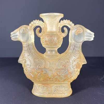 China, Qing Dynasty, early 19th century, candlestick in the form of a small vase surrounded by two rams.