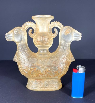 China, Qing Dynasty, early 19th century, candlestick in the form of a small vase surrounded by two rams.
