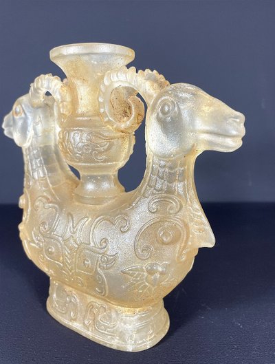 China, Qing Dynasty, early 19th century, candlestick in the form of a small vase surrounded by two rams.