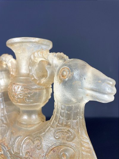 China, Qing Dynasty, early 19th century, candlestick in the form of a small vase surrounded by two rams.