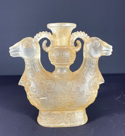China, Qing Dynasty, early 19th century, candlestick in the form of a small vase surrounded by two rams.