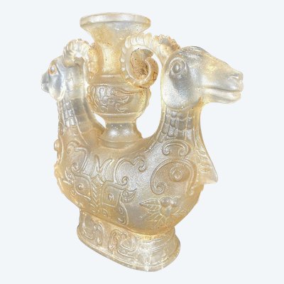 China, Qing Dynasty, early 19th century, candlestick in the form of a small vase surrounded by two rams.