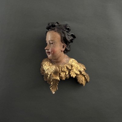 Head of a cherub in carved polychrome and gilded wood, 17th century, entourage of Ignaz Günther