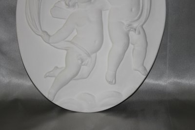 Pair of plaster bas-reliefs decorated with cherubs in the Louis XVI style, 20th century.
