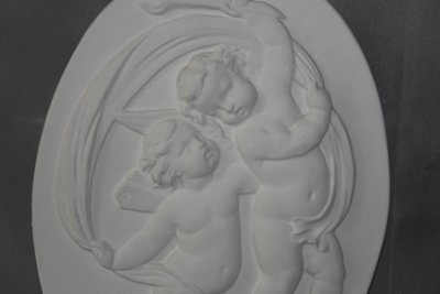 Pair of plaster bas-reliefs decorated with cherubs in the Louis XVI style, 20th century.