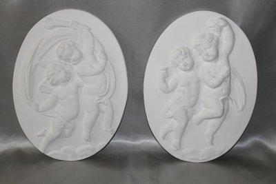 Pair of plaster bas-reliefs decorated with cherubs in the Louis XVI style, 20th century.