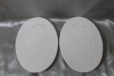 Pair of plaster bas-reliefs decorated with cherubs in the Louis XVI style, 20th century.