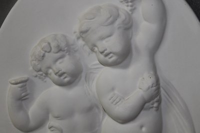 Pair of plaster bas-reliefs decorated with cherubs in the Louis XVI style, 20th century.