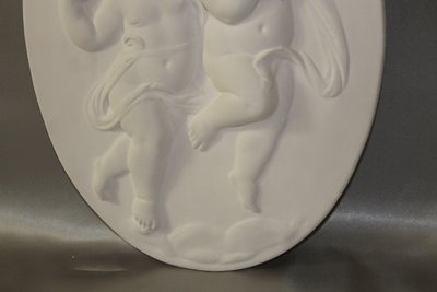 Pair of plaster bas-reliefs decorated with cherubs in the Louis XVI style, 20th century.